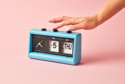 Hand Turning off an Old Fashioned Alarm Clock