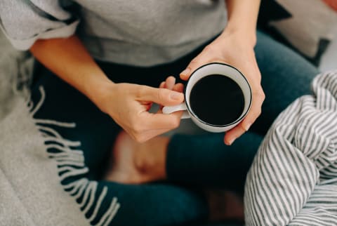 Overhead Photo of a Woman Enjoying a Cup of Coffee on Her Couch