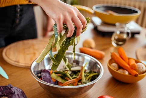 Collecting Vegetable Leftovers For Compost 