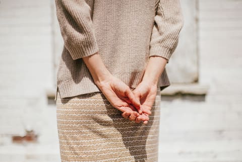 Woman Standing With Her Back to the Sun, Hands Held Behind Her Back