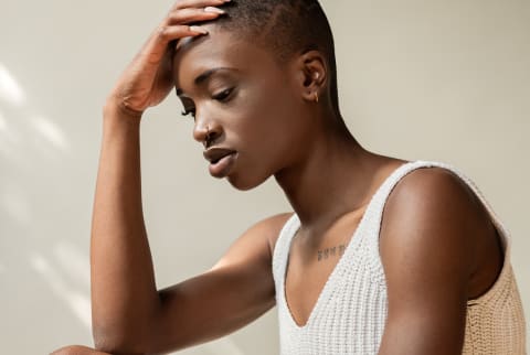 Thoughtful Woman Leans Her Hand To Her Forehead