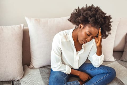 Young Woman At Home With A Headache