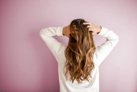 Woman with long hair faces away from the camera